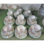 A collection of Minton Haddon Hall pattern wares comprising teapot, sixteen cups, seventeen