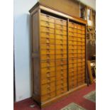 An early 20th century oak floorstanding filing cabinet fitted with a segmented tower arrangement