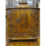 An antique walnut veneered table cabinet Austrian/possibly German fitted with an arrangement of nine
