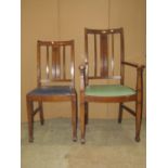 A set of seven (6+1) oak framed dining chairs, the backs with carved splats, drop in seats, raised