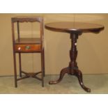 A Georgian mahogany occasional table the circular one piece top raised on a turned vase shaped
