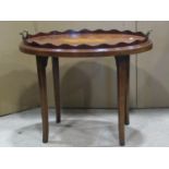 An Edwardian mahogany serving tray of oval form with inlaid detail and shaped gallery raised on a