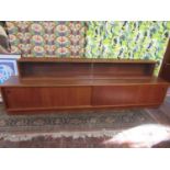 1960s Danish teak long display unit with a raised glazed back with two slide doors over a base