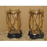 A pair of contemporary candle lanterns with ebonised bases and cast brass effect open frames, 39
