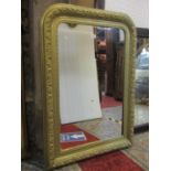 A late 19th century French wall mirror with stepped and moulded arched frame, with foliate detail