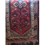 Persian wool runner the central red ground field with repeating geometric detail within