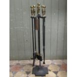 A cast iron floorstanding companion set with polished brass effect pommels, 82 cm high