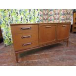 1970s teak sideboard fitted with three short drawers and two cupboard doors, 151cm long x 72cm high