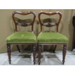 A set of six Victorian mahogany dining chairs, the kidney shaped backs with carved splats over green