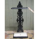 A cast iron umbrella stand, with foliate detail and removeable rectangular drip tray, the back