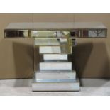 A decorative contemporary hall/console table with bevelled edge mirror panels, the rectangular top