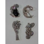 Four silver brooches / pendants set with marcasite, to include a tennis racket and a mouse with ruby