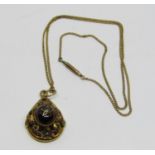 Victorian yellow metal mourning pendant set with a cabochon garnet, central diamond set star and