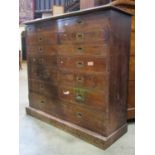 A late Victorian mahogany chest fitted with an arrangement of thirteen drawers, with brass flush