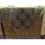 An Afghan wool rug principally in a brown amber colourway, the central medallions within repeating