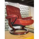 An Ekornes Stressless adjustable lounge chair with soft stitched burgundy coloured leather