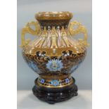 A traditional Chinese cloisonné vase with cast dragon handles and repeating floral geometric