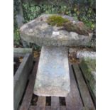 A weathered natural stone staddlestone of square tapered form with domed cap approx 80 cm high