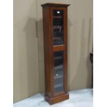 A contemporary upright mahogany cabinet, enclosed by two glazed panelled doors, to hold around 100