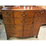 A Georgian mahogany bow fronted chest enclosing an unusual arrangement of ten drawers, varying