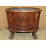 A Georgian mahogany wine cooler, the body of oval form enclosing a zinc lined interior, anthemion,
