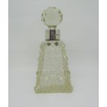 A cut glass perfume bottle of square cut tapering form with silver collar beneath a prism cut