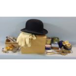 A bowler hat by Hydes of Glebe Street, Stoke on Trent and a pair of suede gloves, together with a