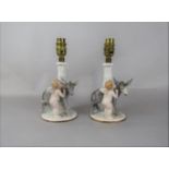 A pair of Bavarian table lamp bases modelled as cherubs and donkeys, with printed marks to base