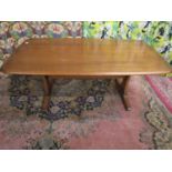 Ercol Golden Dawn elm refectory coffee table upon two tapered supports united by a stretcher, 52cm