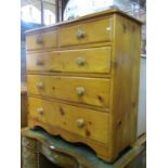 A Victorian stripped pine bedroom chest of two short over three long graduated drawers with shaped