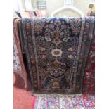 A Persian wool runner with ink blue ground, abstract and floral detail within narrow running
