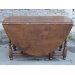A good quality reproduction old English style oak oval drop leaf gateleg dining table with