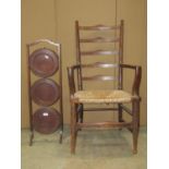 An Edwardian mahogany three tier folding cake stand and a further ladderback armchair with rush seat