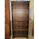 A pair of freestanding contempary dark stained oak freestanding open bookcases with moulded