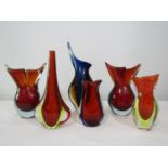 A collection of stylised heavy glass Scandinavian tear drop type vases, to include a pair in red and