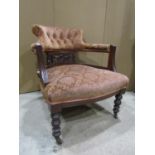 An Edwardian drawing room tub chair with carved and pierced framework, upholstered seat and back