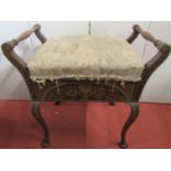 An inlaid Edwardian piano stool, with scrolling urn, swag and other detail, rising lid and set of