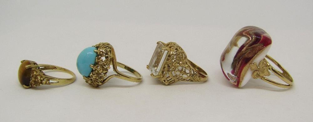 Four stylised 9ct dress rings comprising a tiger's eye, a turquoise, a topaz (16.9g total) and an - Image 2 of 2