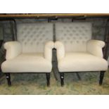 A pair of traditional button back armchairs in an oatmeal coloured fabric raised on turned and