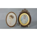 An Edwardian miniature painted portrait, oval, young boy holding an apple in a brass framework