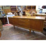 Nathan teak long sideboard fitted with three long drawers, flanked by a fall front and two