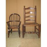A 19th century child's Windsor hoop back elbow chair with elm seat on turned supports and