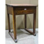 A vintage stained pine child's school desk with hinged box slope, ceramic inkwell and pen rest,