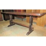 An antique old English style oak refectory table with planked top raised on shaped supports united