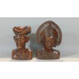 Two Indonesian carved hardwood busts, male and female characters, 32cm high