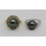 Two 18ct black pearl and diamond rings; one in bi-colour gold and the other in white, both size O,