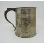 A Georgian silver half pint tankard, the reeded body interspersed with trailing floral bands, with
