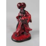 A Royal Doulton Flambe figure of the Lamp Seller HN3278