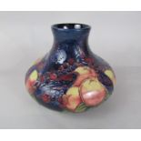 A large Moorcroft vase of squat form in the Finch and Fruit pattern with impressed marks to base and