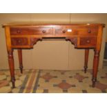A Victorian mahogany side table fitted with an arrangement of four frieze drawers, with turned